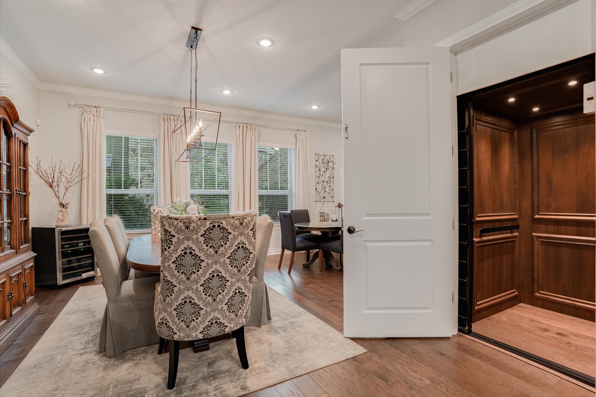 309 Adams Street Georgetown, TX 78628 - Photo 7 of 30 Dining room with light wood-type flooring, ornamental molding, elevator, and suspended lighting