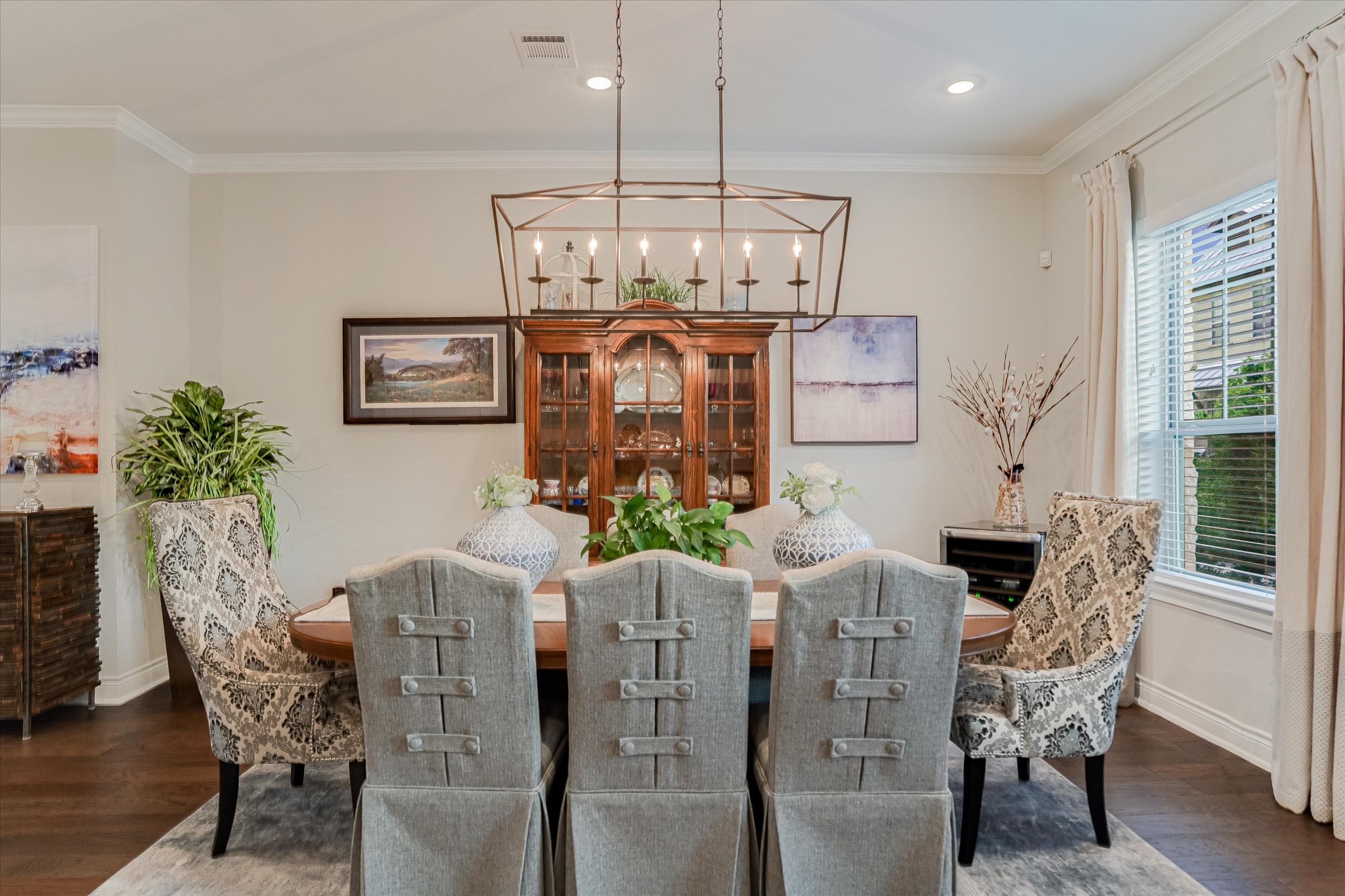 309 Adams Street Georgetown, TX 78628 - Photo 8 of 30 Dining area featuring dark wood-style floors, crown molding, and a chandelier