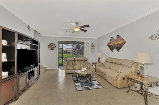 a living room with furniture and kitchen view