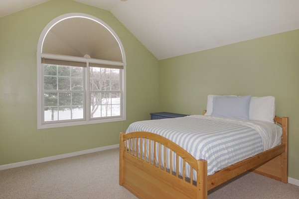 53 Lancaster Road, Unit 10 Clinton, MA 01510 - Photo 13 of 20 a bedroom with a bed and a window