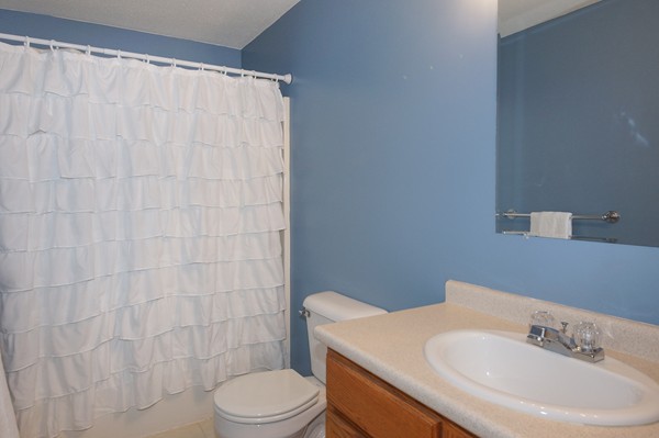 53 Lancaster Road, Unit 10 Clinton, MA 01510 - Photo 14 of 20 a bathroom with a sink a toilet and shower curtain