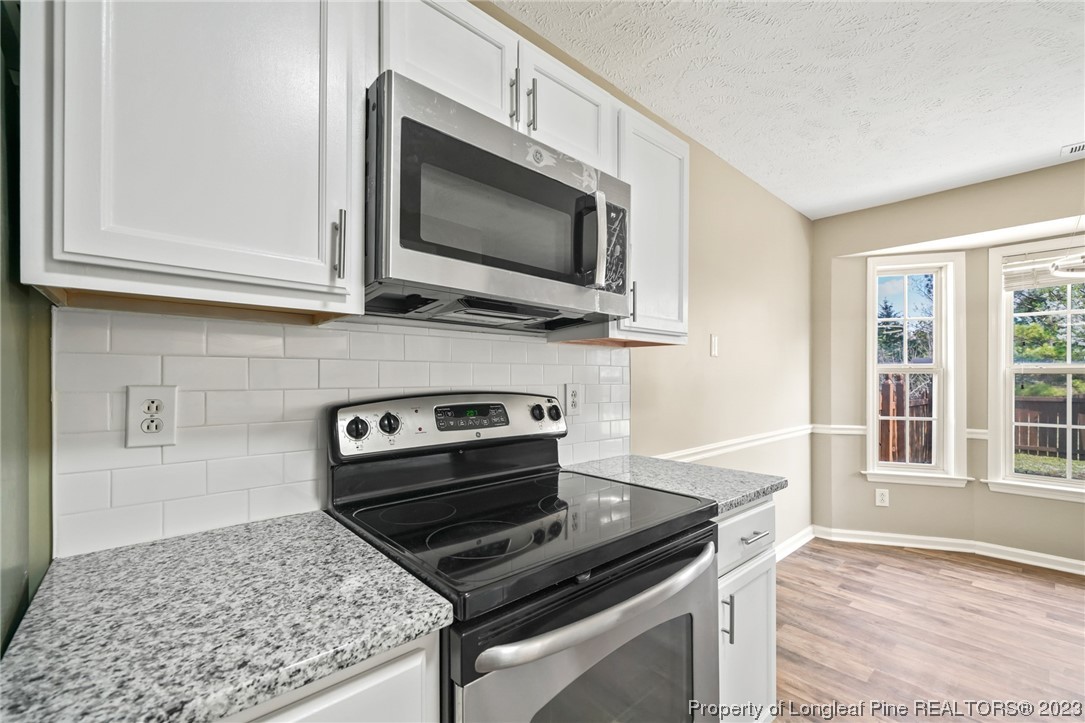 149 Cavalier Drive Raeford, NC 28376 - Photo 11 of 31 a kitchen with a stove and a microwave