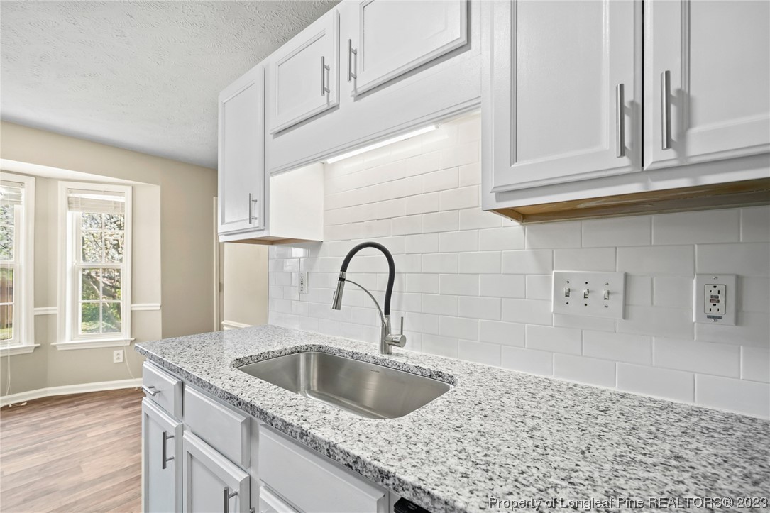 149 Cavalier Drive Raeford, NC 28376 - Photo 12 of 31 a kitchen with granite countertop a sink and cabinets