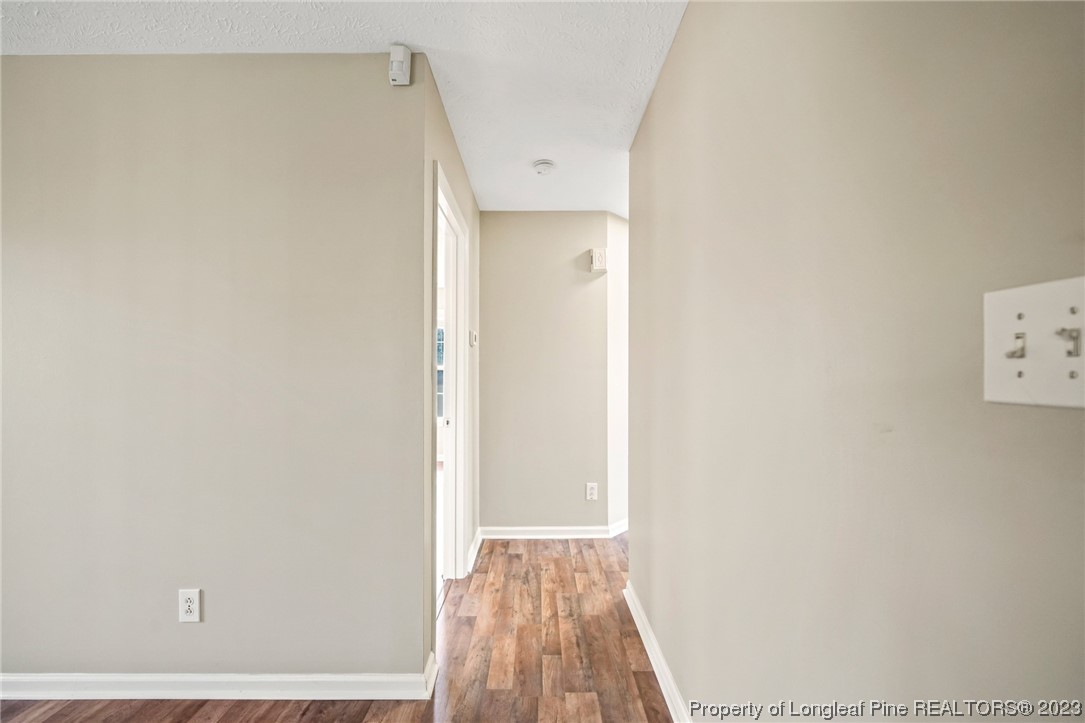 149 Cavalier Drive Raeford, NC 28376 - Photo 14 of 31 a view of a hallway with wooden floor