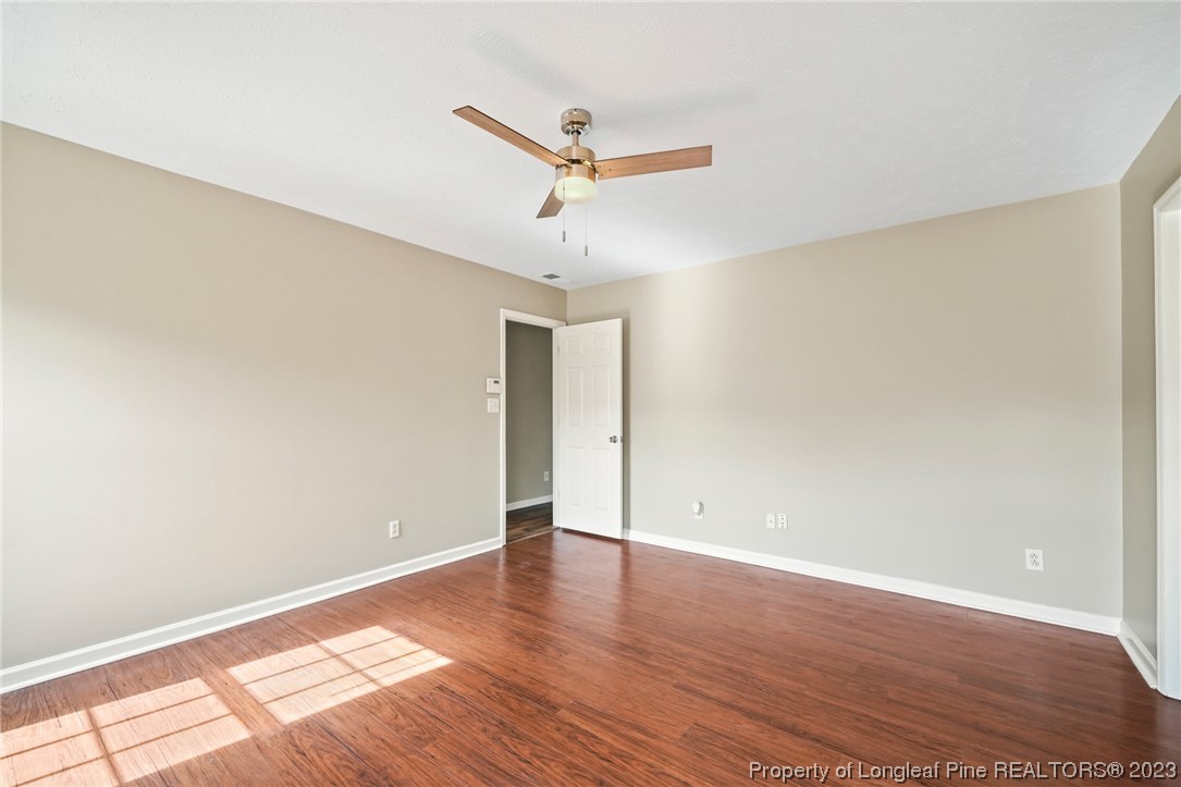 149 Cavalier Drive Raeford, NC 28376 - Photo 16 of 31 a view of a big room with wooden floor and a ceiling fan