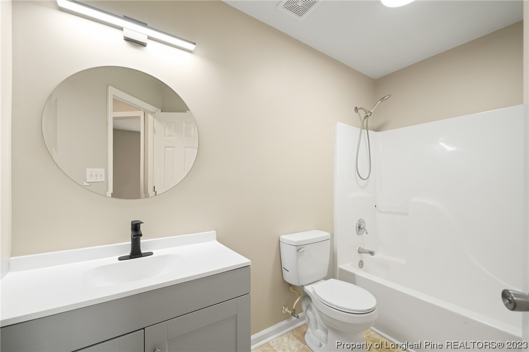 149 Cavalier Drive Raeford, NC 28376 - Photo 25 of 31 a bathroom with a sink a toilet and a mirror
