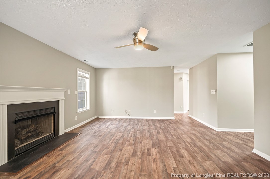 149 Cavalier Drive Raeford, NC 28376 - Photo 7 of 31 a view of empty room with wooden floor and fireplace