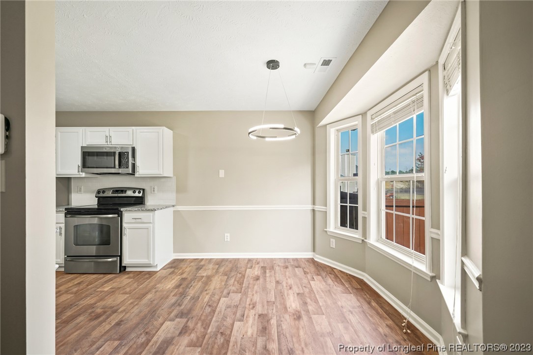 149 Cavalier Drive Raeford, NC 28376 - Photo 8 of 31 a view of a kitchen with wooden floor and electronic appliances
