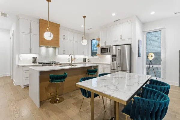 a kitchen with refrigerator and sink