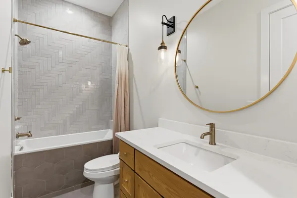 a bathroom with a sink a toilet and a mirror