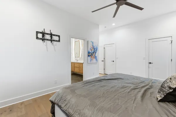 a bedroom with a bed and a chandelier