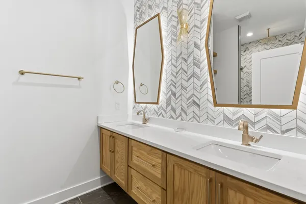 a bathroom with a double vanity sink and mirror
