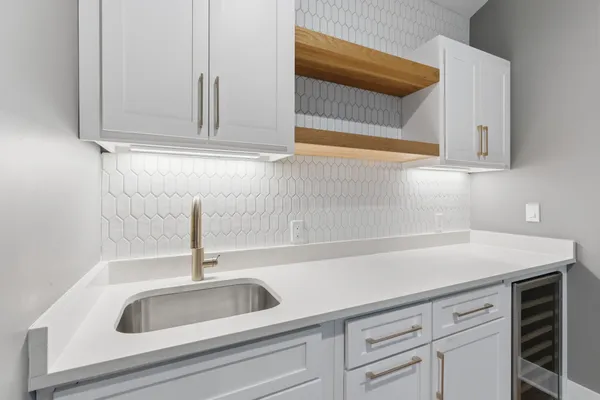 a kitchen with white cabinets and a sink