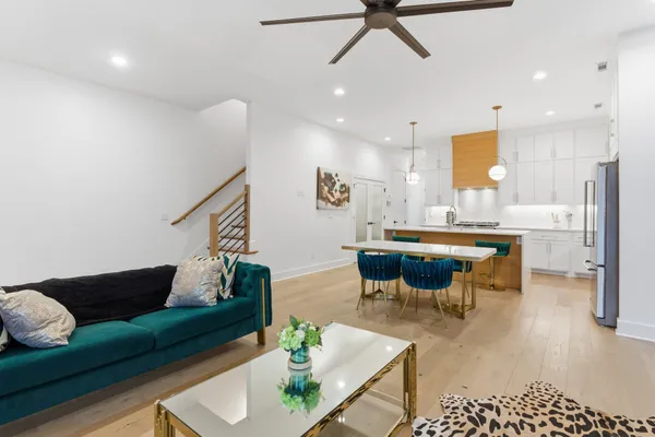 a living room with furniture kitchen view and a table