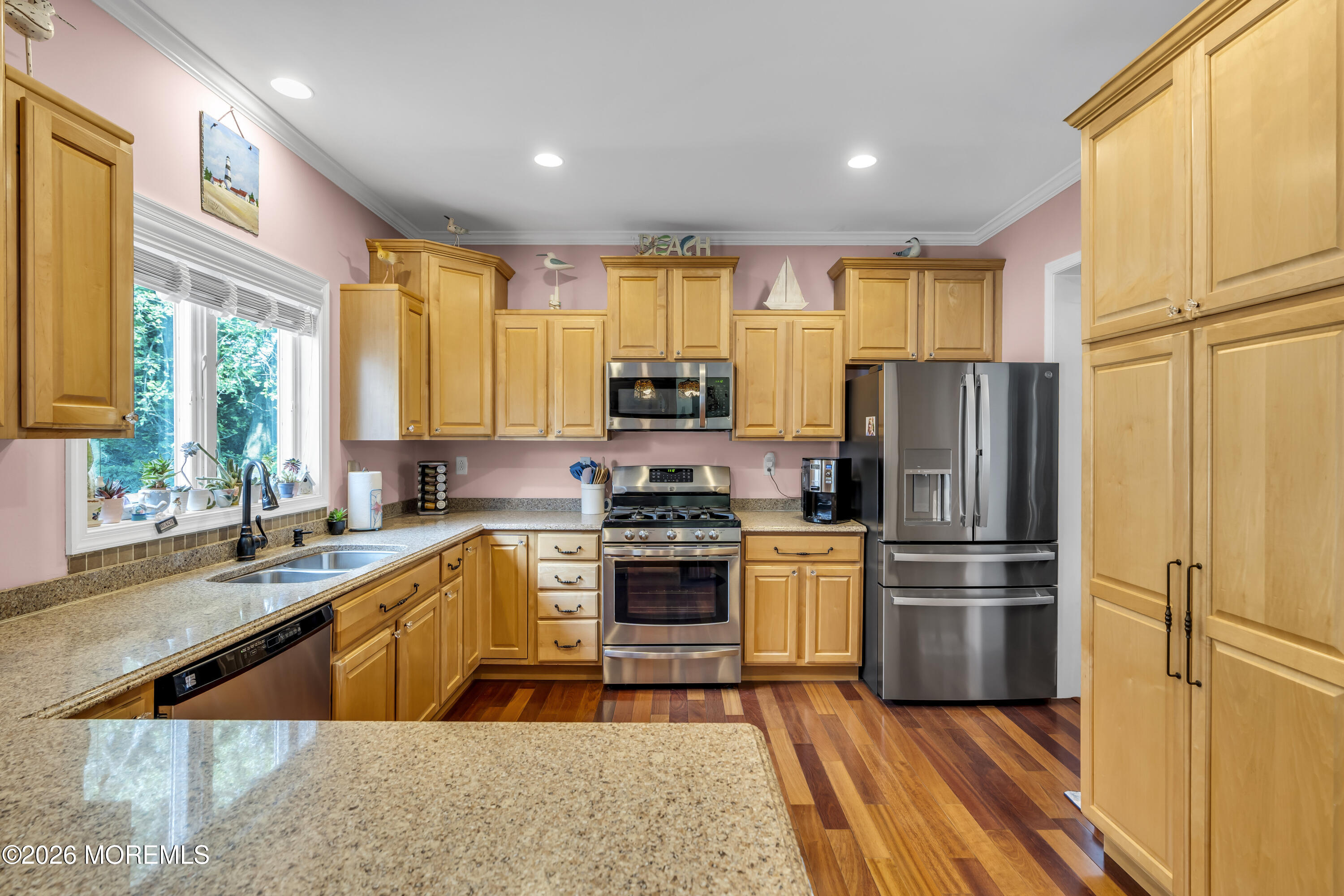 165 Kingsley Street Long Branch, NJ 07740 - Photo 21 of 55 a kitchen with stainless steel appliances granite countertop a refrigerator a sink dishwasher a stove and white countertops with wooden floor