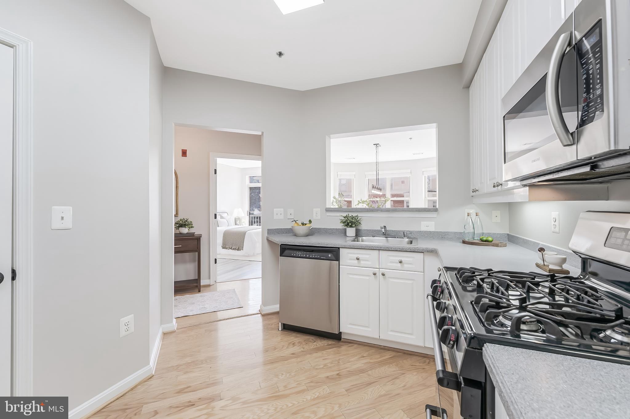 1851 Stratford Park Place, Unit 212 Reston, VA 20190 - Photo 11 of 45 a kitchen with a sink stove top oven and refrigerator
