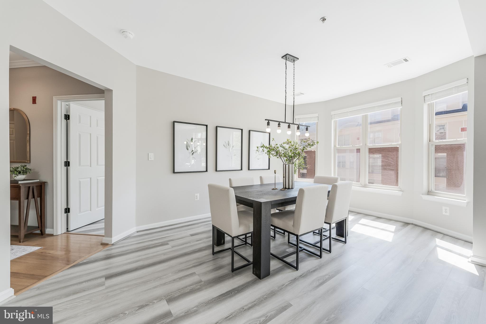 1851 Stratford Park Place, Unit 212 Reston, VA 20190 - Photo 14 of 45 a view of a dining room with furniture window and wooden floor