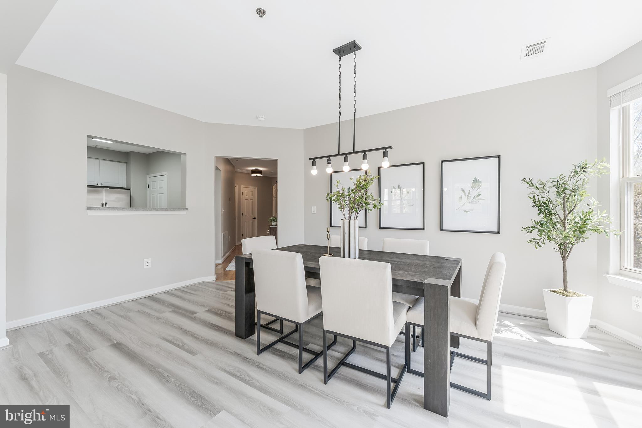 1851 Stratford Park Place, Unit 212 Reston, VA 20190 - Photo 15 of 45 a view of a dining room with furniture window and wooden floor