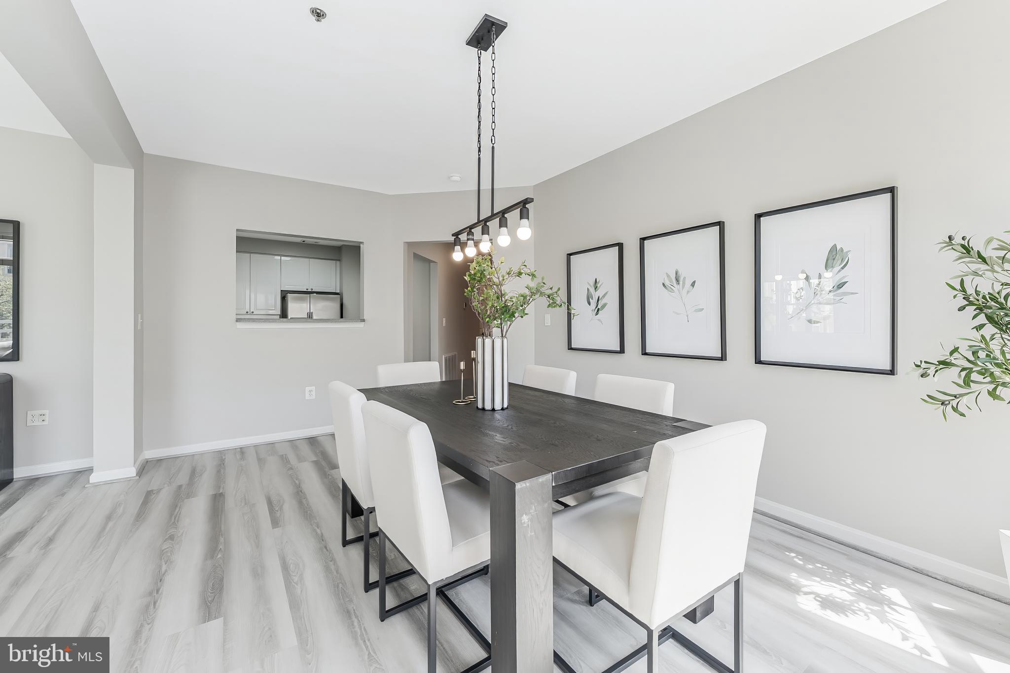 1851 Stratford Park Place, Unit 212 Reston, VA 20190 - Photo 16 of 45 a view of a dining room with furniture window and wooden floor