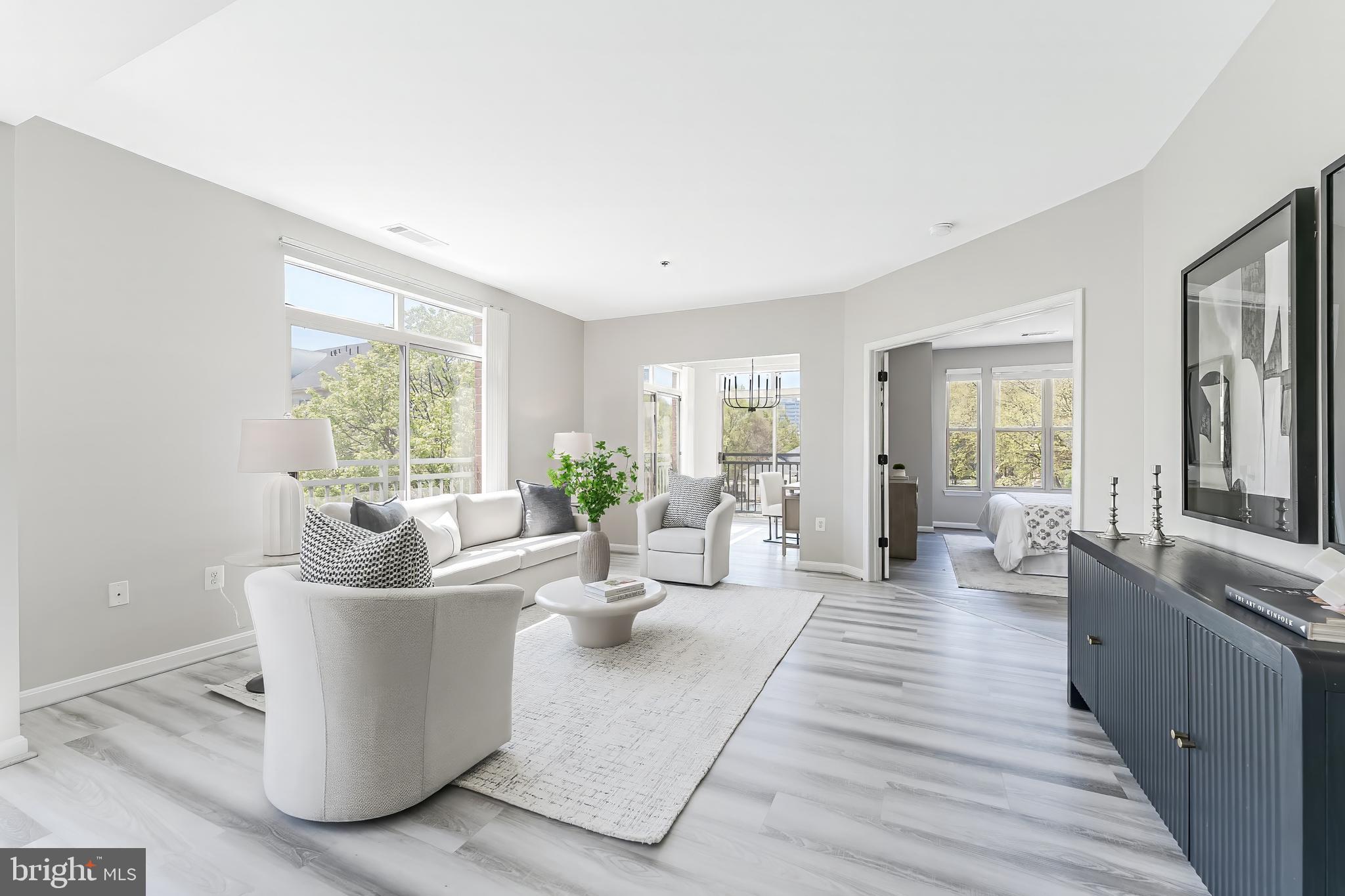 1851 Stratford Park Place, Unit 212 Reston, VA 20190 - Photo 17 of 45 a living room with furniture and wooden floor