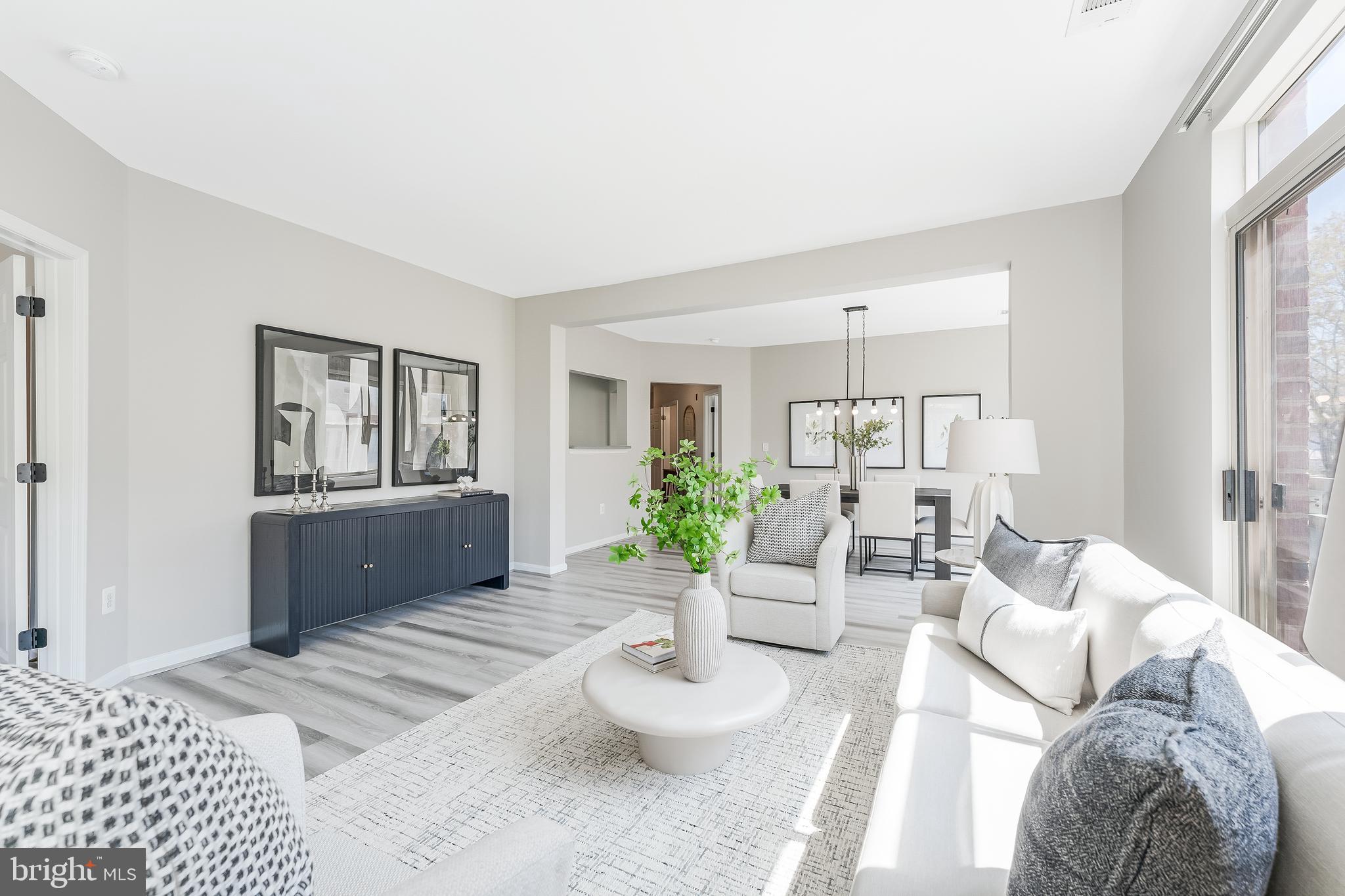 1851 Stratford Park Place, Unit 212 Reston, VA 20190 - Photo 19 of 45 a living room with furniture and a wooden floor
