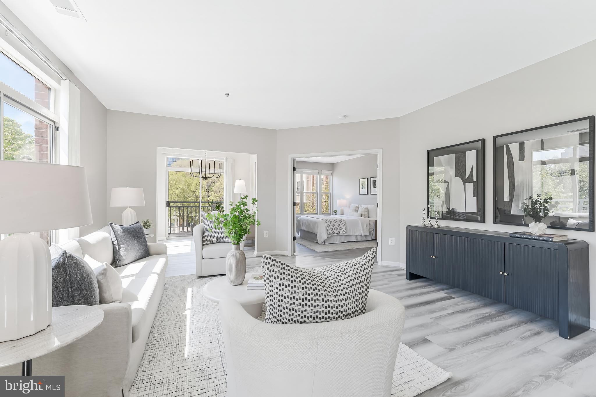 1851 Stratford Park Place, Unit 212 Reston, VA 20190 - Photo 20 of 45 a living room with furniture and a large window
