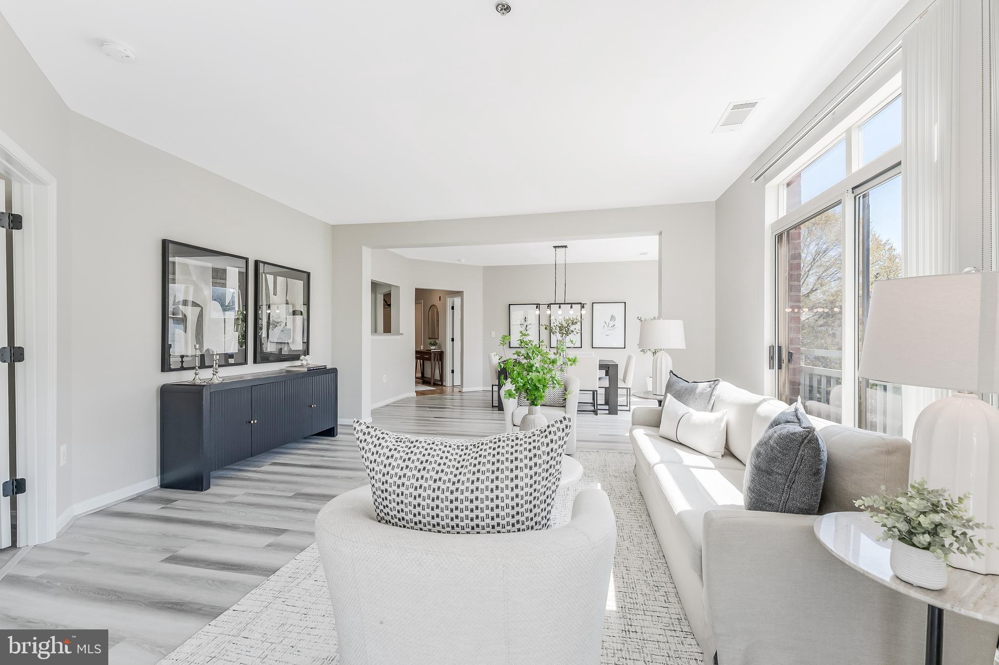 1851 Stratford Park Place, Unit 212 Reston, VA 20190 - Photo 21 of 45 a living room with furniture and a large window