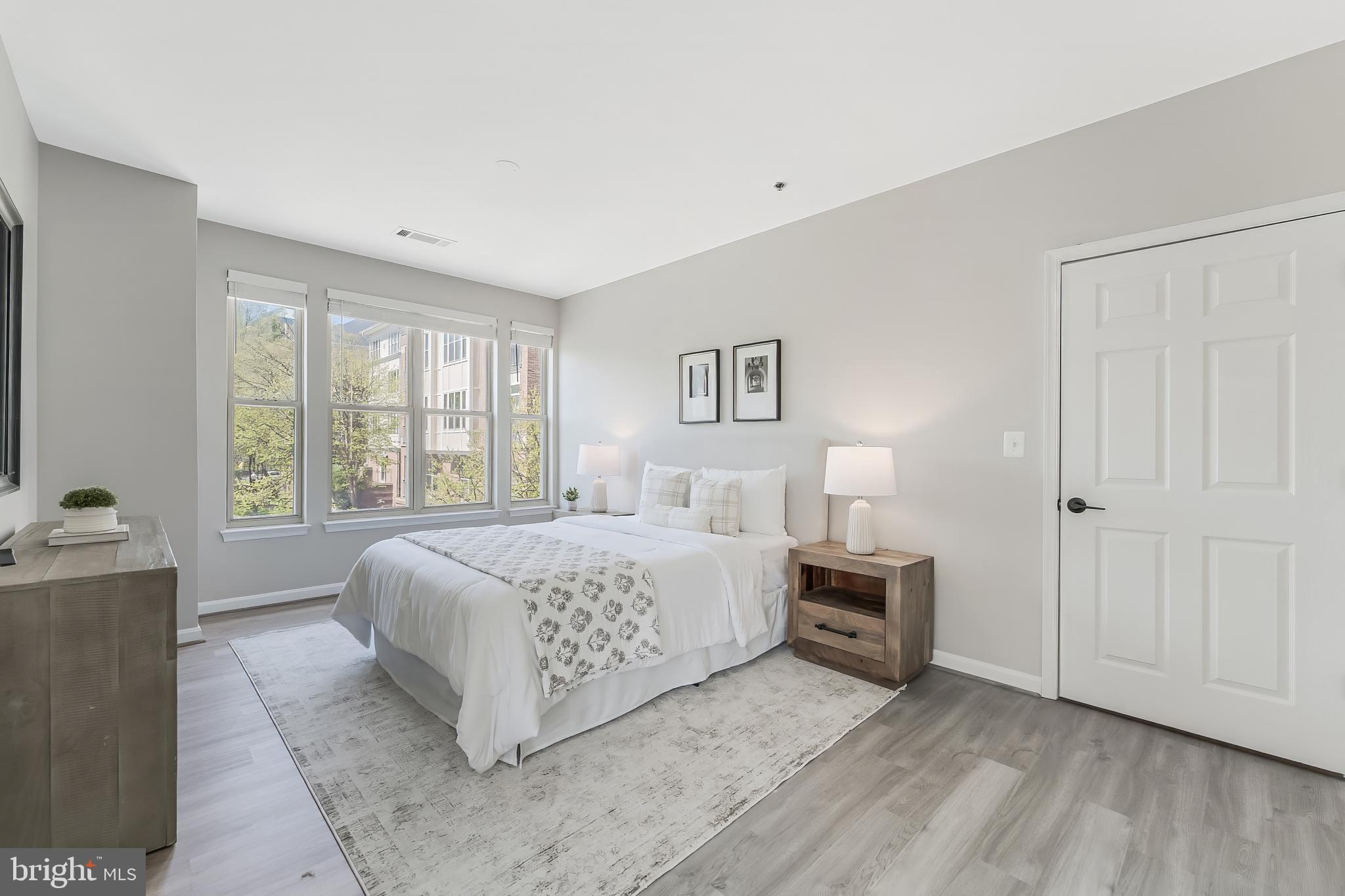 1851 Stratford Park Place, Unit 212 Reston, VA 20190 - Photo 24 of 45 a bedroom with a bed and a couch