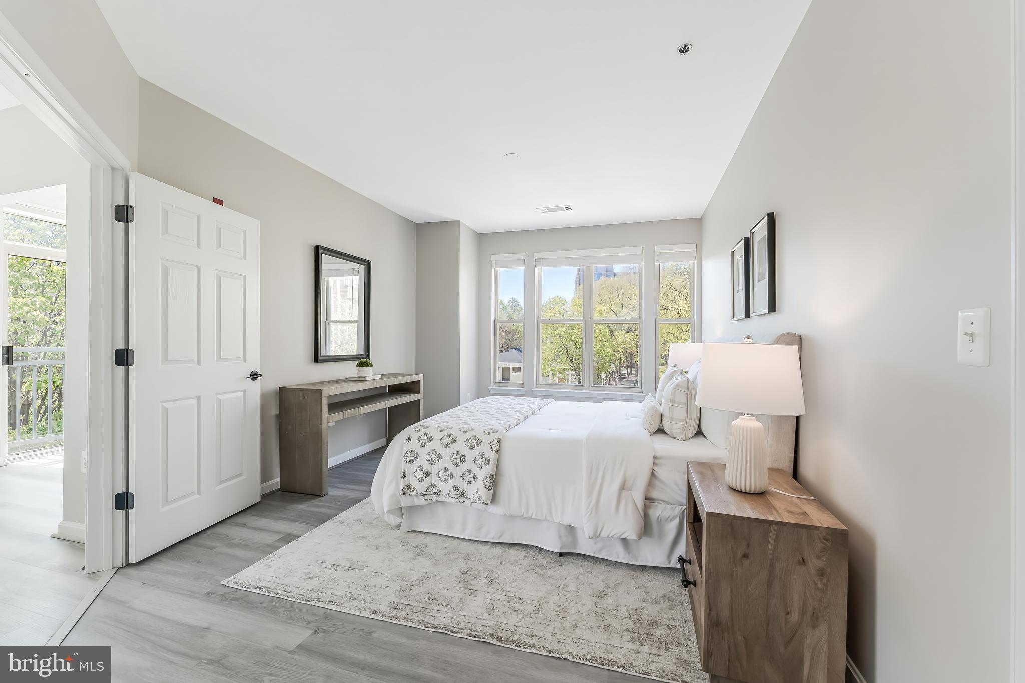 1851 Stratford Park Place, Unit 212 Reston, VA 20190 - Photo 25 of 45 a room with a bed and a table