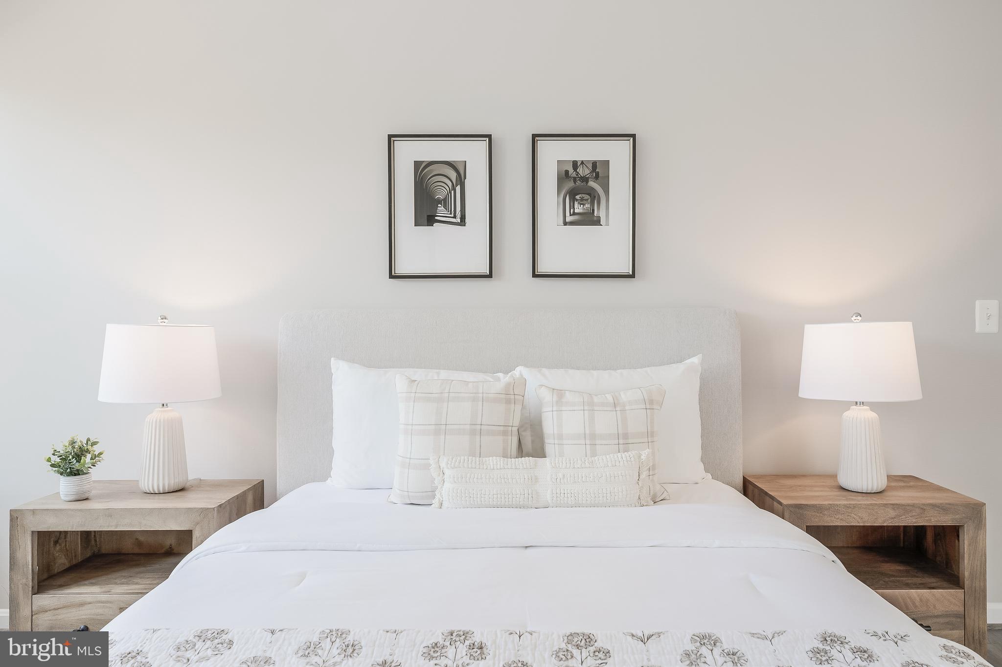 1851 Stratford Park Place, Unit 212 Reston, VA 20190 - Photo 29 of 45 a bedroom with a bed and a lamp
