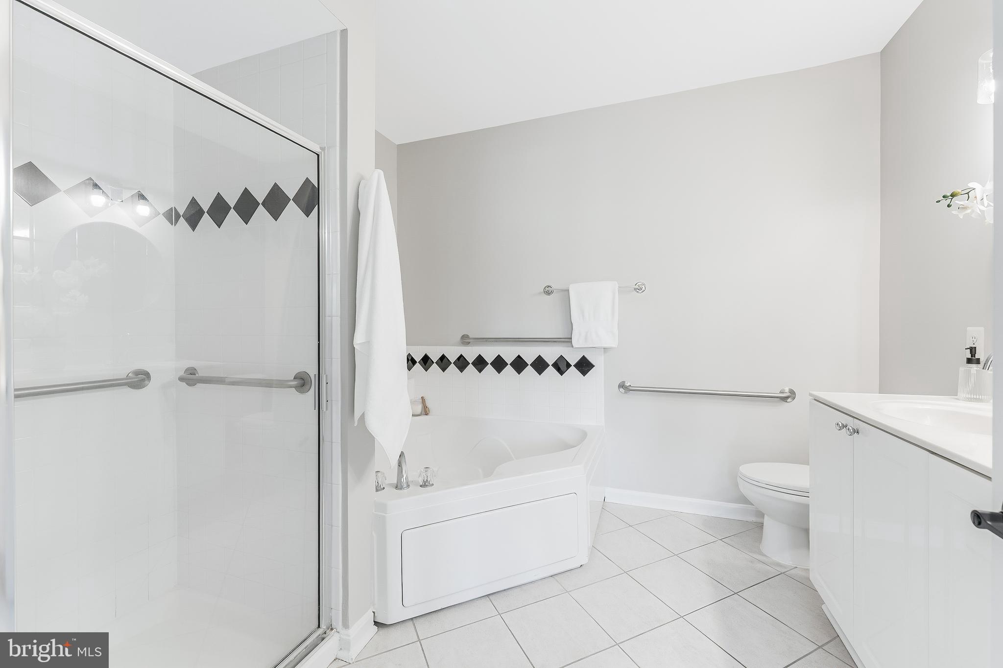 1851 Stratford Park Place, Unit 212 Reston, VA 20190 - Photo 32 of 45 a bathroom with a bathtub and a toilet