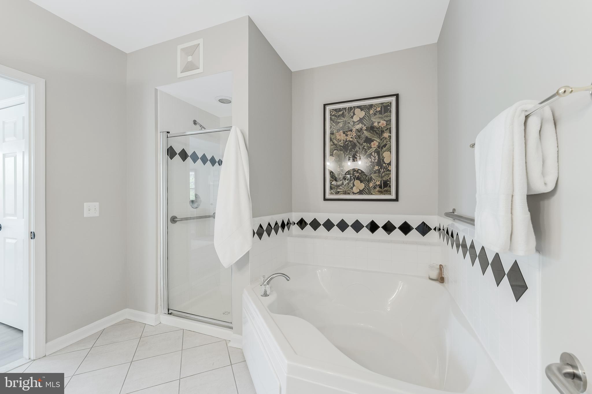 1851 Stratford Park Place, Unit 212 Reston, VA 20190 - Photo 34 of 45 a bathroom with a bathtub and a shower