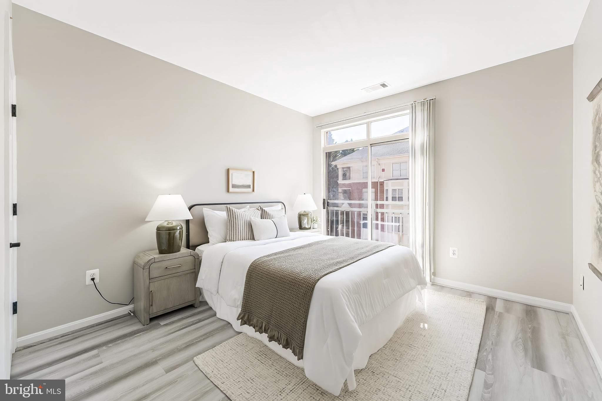 1851 Stratford Park Place, Unit 212 Reston, VA 20190 - Photo 37 of 45 a bedroom with a large bed and a window