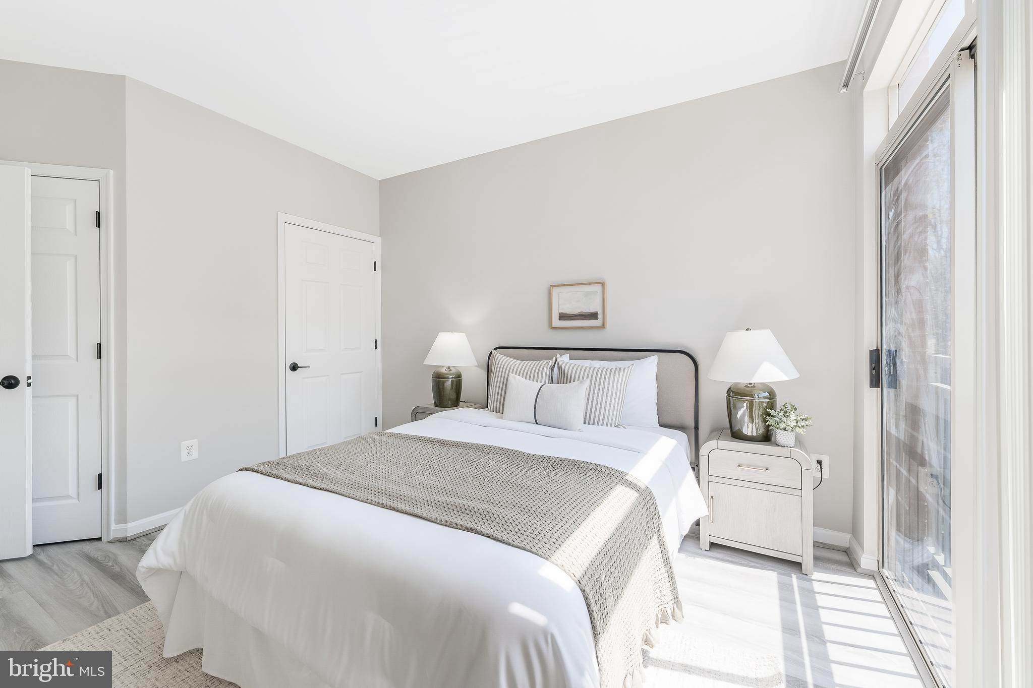 1851 Stratford Park Place, Unit 212 Reston, VA 20190 - Photo 38 of 45 a bedroom with a bed and a lamp