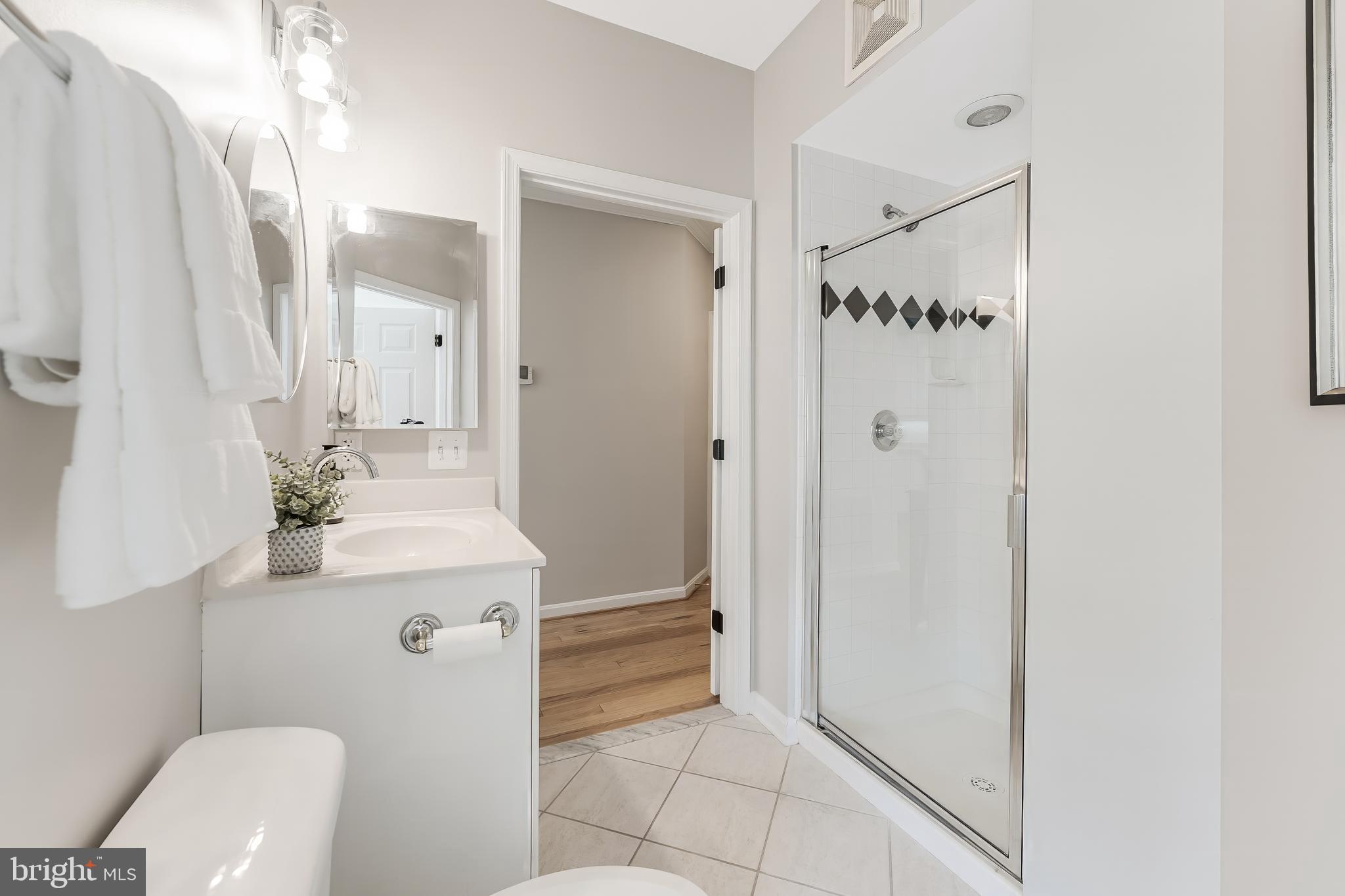 1851 Stratford Park Place, Unit 212 Reston, VA 20190 - Photo 41 of 45 a bathroom with a sink a toilet and shower