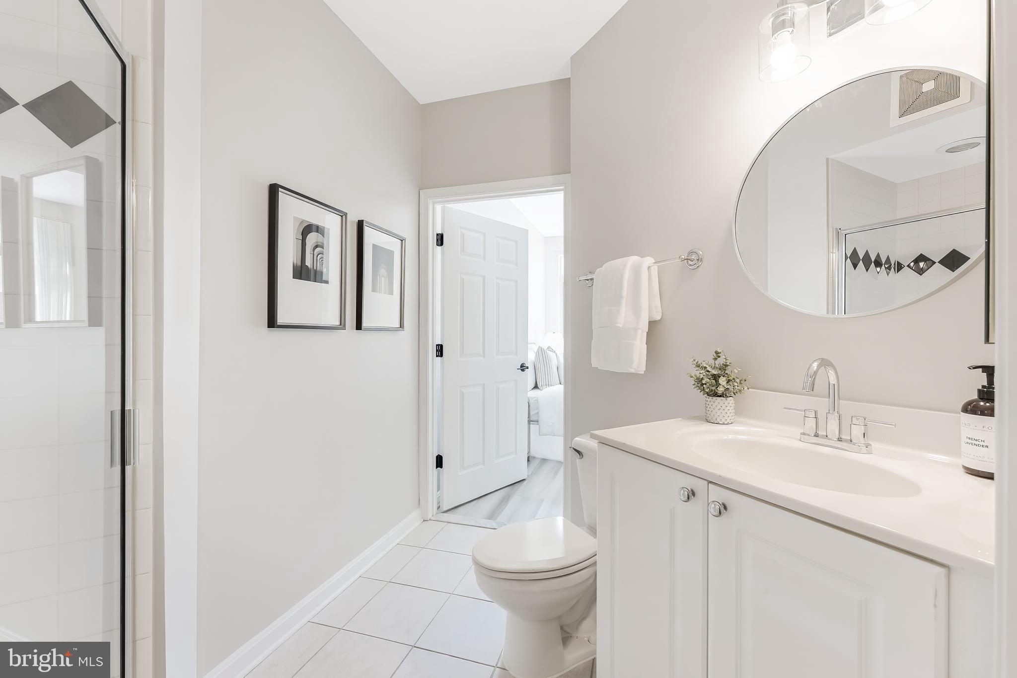 1851 Stratford Park Place, Unit 212 Reston, VA 20190 - Photo 42 of 45 a bathroom with a sink a toilet and shower