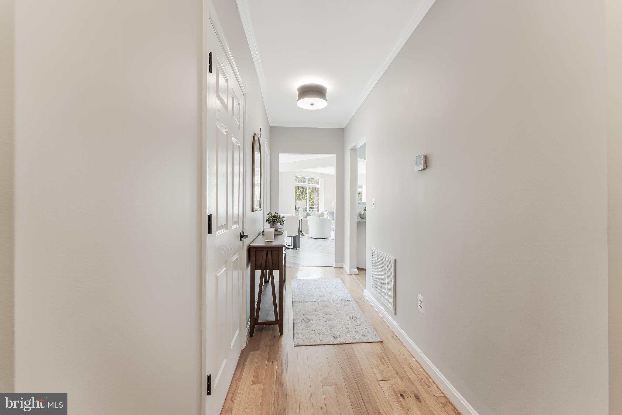 1851 Stratford Park Place, Unit 212 Reston, VA 20190 - Photo 5 of 45 a view of a hallway with wooden floor and a bathroom