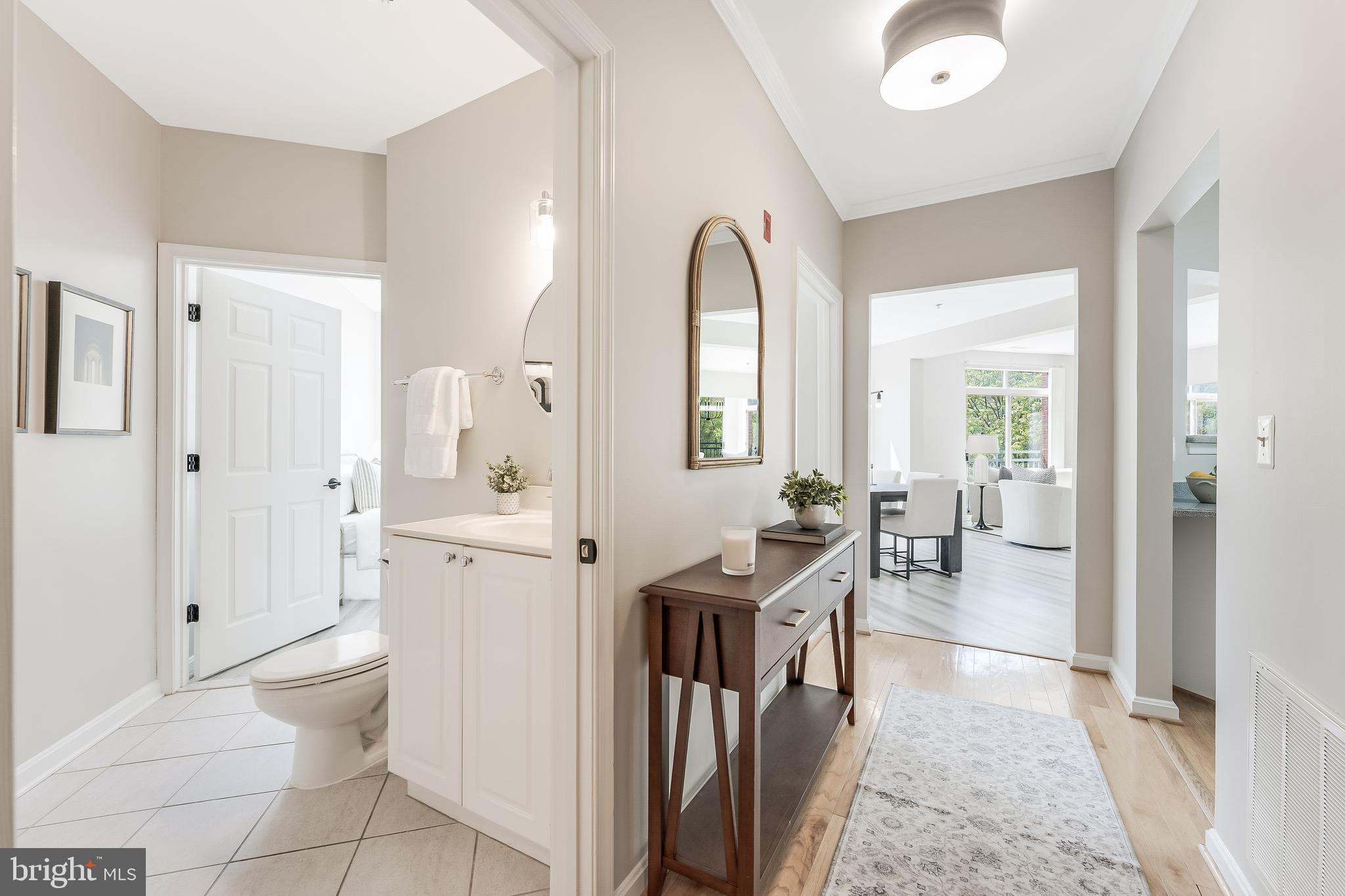 1851 Stratford Park Place, Unit 212 Reston, VA 20190 - Photo 6 of 45 a view of a hallway with bathroom and wooden floor