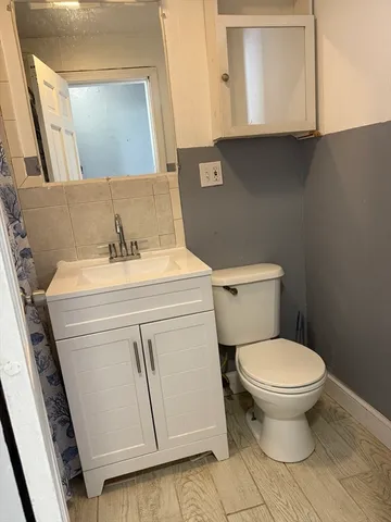 a bathroom with a sink toilet and mirror