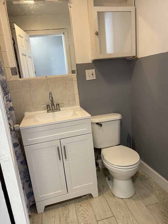 157 Vernon Street, Unit 3 Worcester, MA 01610 - Photo 15 of 15 a bathroom with a sink toilet and mirror