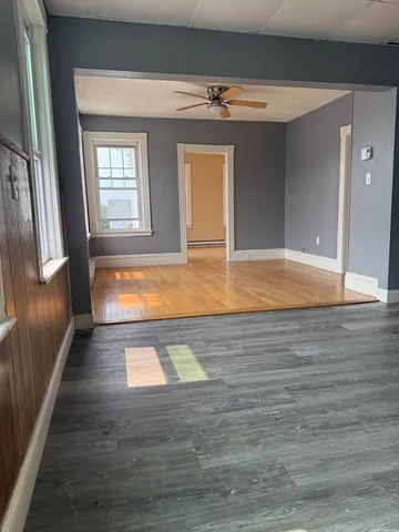 a view of empty room with wooden floor