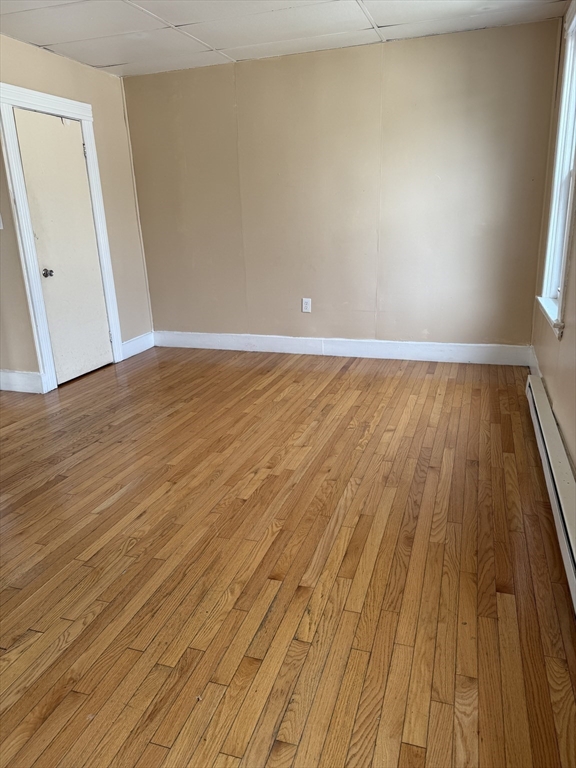157 Vernon Street, Unit 3 Worcester, MA 01610 - Photo 8 of 15 an empty room with wooden floor