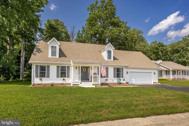 a front view of a house with a yard table and chairs