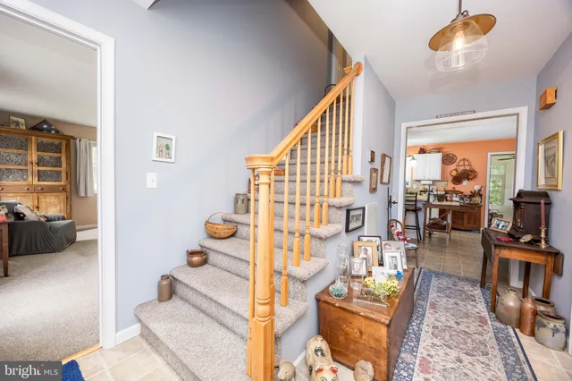 a living room with furniture a flat screen tv and a table
