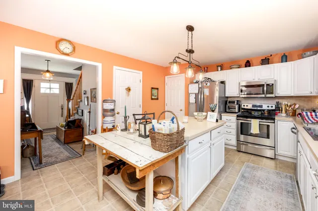 a kitchen with sink cabinets and appliances