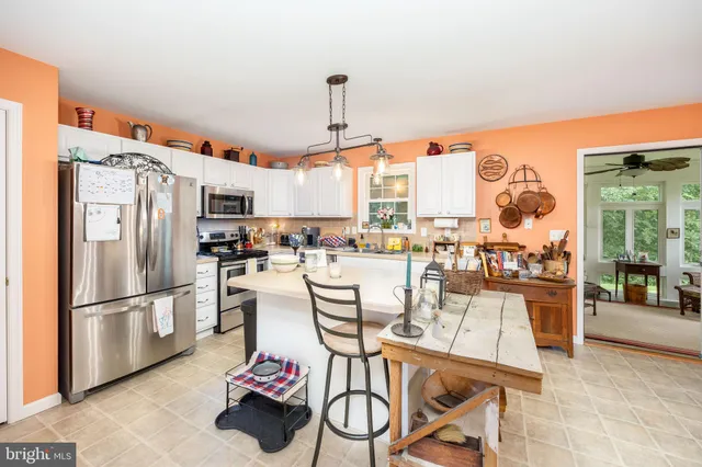 a kitchen with a sink a stove and a microwave