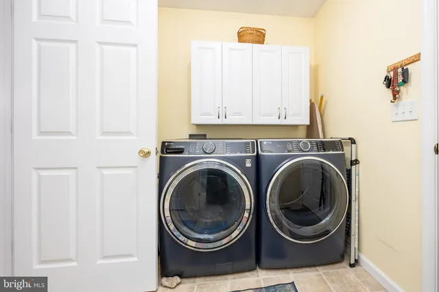 a spacious bedroom with a bed a couch and dresser