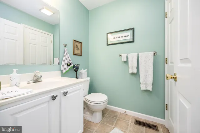 a room with a sink vanity and mirror