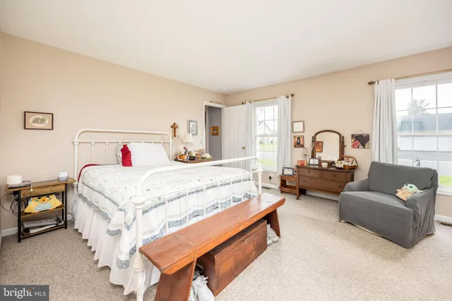 a white toilet sitting next to a bathroom sink and a shower