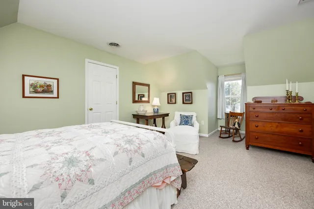 a living room with furniture and kitchen area